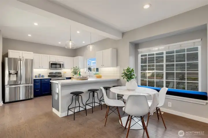 Large kitchen is open to dining. We love the window seat with custom cushion.