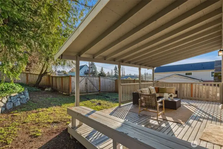 Deck off kitchen and dining overlooks the backyard and alley access for parking.