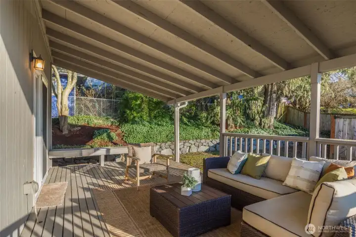 Deck off kitchen and dining overlooks the backyard and alley access for parking.
