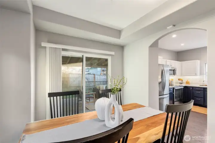 Perspective from dining room to back deck and kitchen.