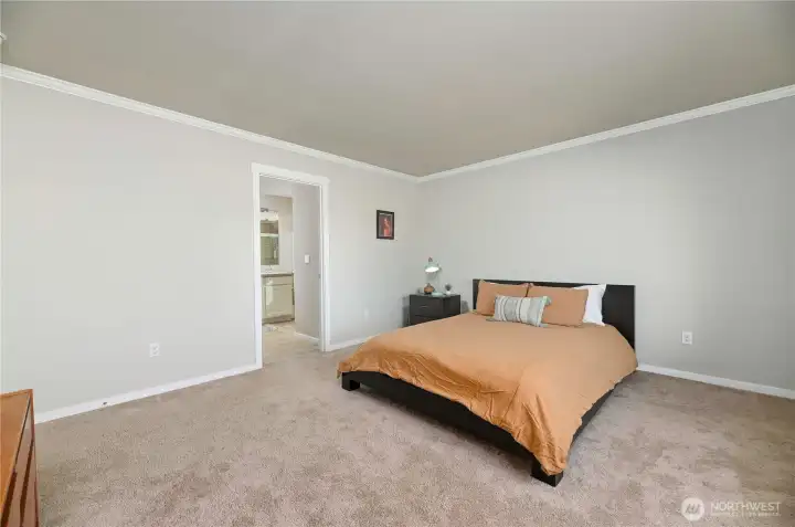 Primary suite with large walk-in closet and 3/4 bath with double sink vanity.