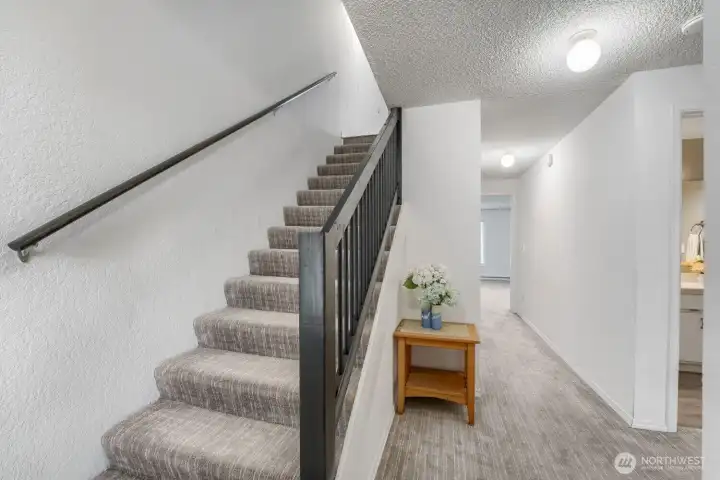 Entry level includes a coat closet and ample storage, including space under the stairs