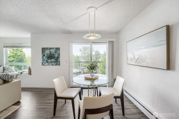 Open flow from living to dining, plus a sliding door to the balcony with scenic views