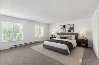 Oversized primary suite (virtual AI staging) has ample space for a king-size bed.  Enjoy waking up to serene lake views
