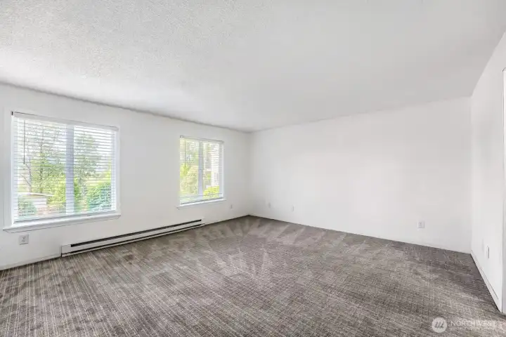 Generously sized primary bedroom with space for a king sized bed & sitting area