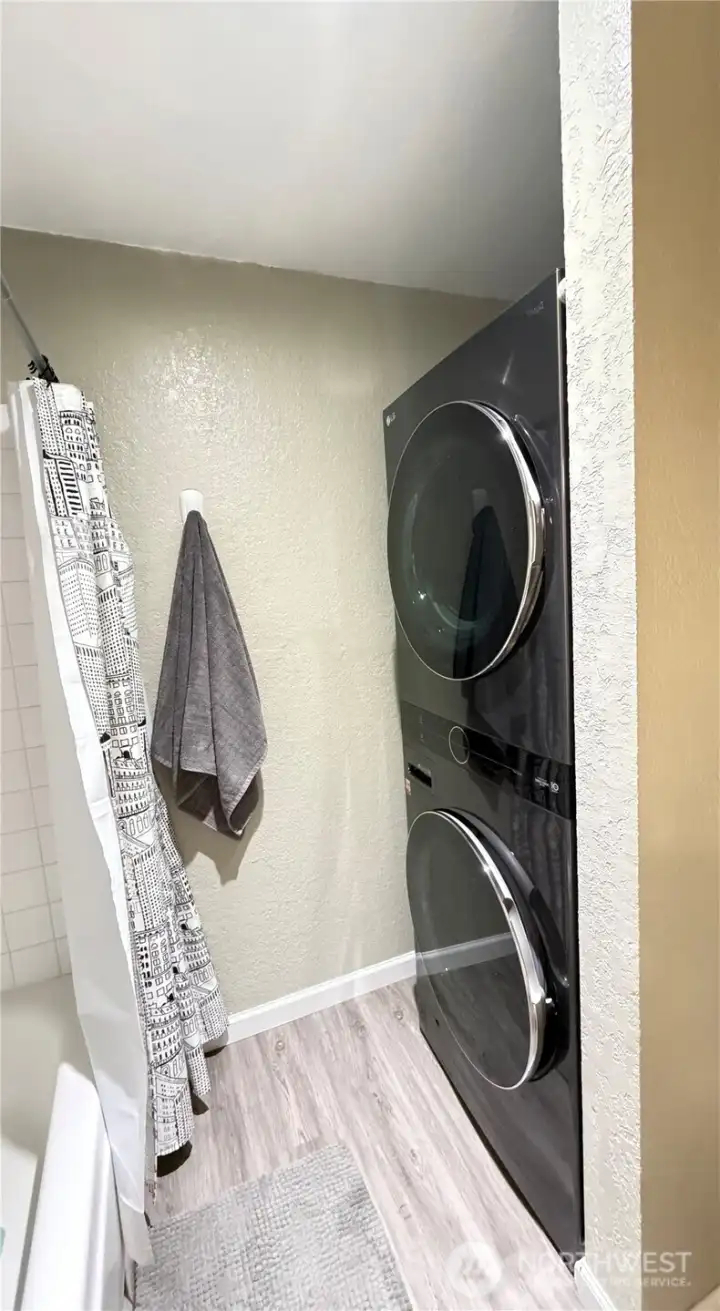 Bathroom has a convenient full-size LG smart washer and dryer