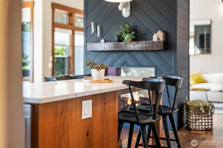 The see through fireplace is the focal point of the kitchen and family room.