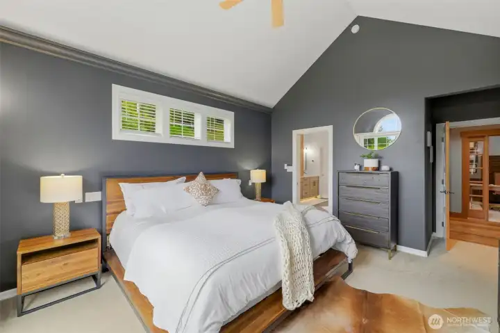 Primary on main with vaulted ceiling and custom lighting inset into the crown molding.