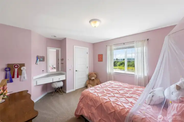 Bedroom 3 with walk in closet and walk in closet built in desk/vanity.