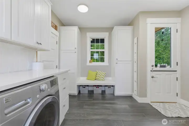 Large utility room off of garage with a 3/4 bath.