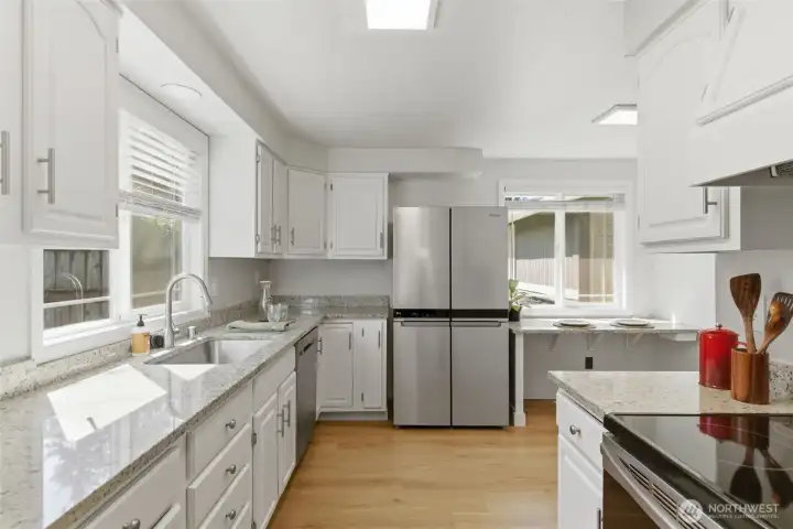 Stainless steel appliances and eat in kitchen counter tops