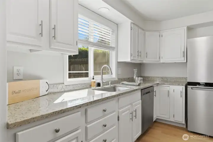Light and bright kitchen with updated countertops and newer appliances throughout