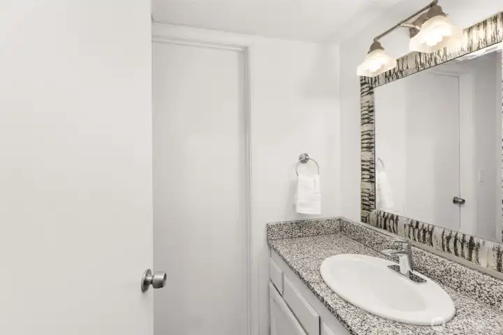 Half bathroom on the main floor. Door into mechanical room.