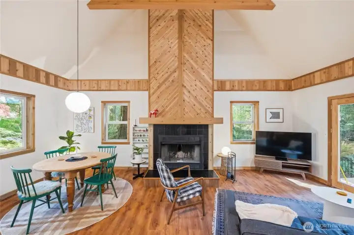 The great room with floor to ceiling fireplace and vaulted ceilings feels light and bright.