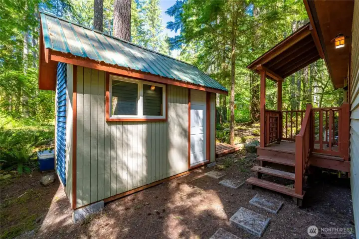 Outside is a large storage shed.