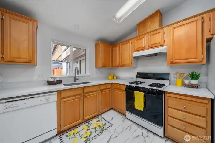 New Quartz countertops, undermount stainless sink and fixtures.  New durable high traffic Rigid core vinyl tile floor, gas range and ample countertop and cabinet space