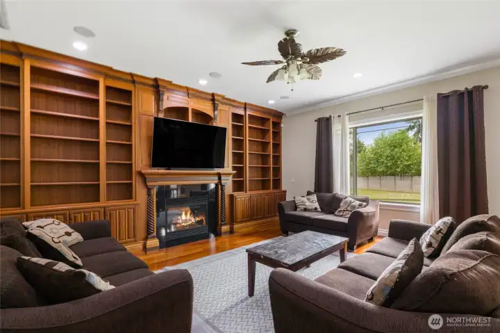 Great Room with floor to ceiling built ins and propane fireplace!