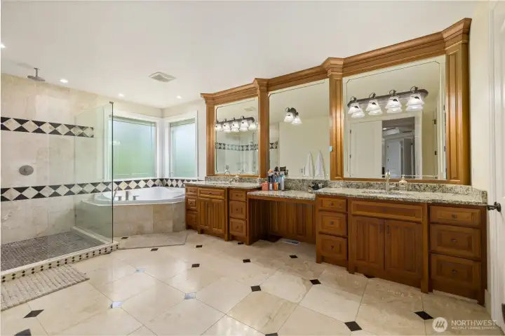 Expansive and gorgeous primary bath with jetted tub, walk in-shower, 2 sinks and his and hers closets.