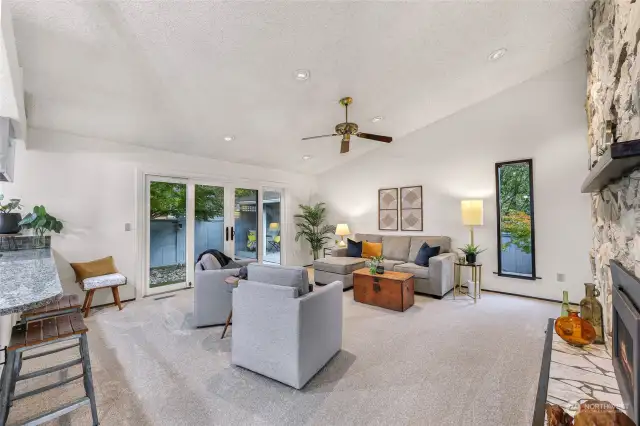 Family room area that has double sliding doors that open up to the back patio