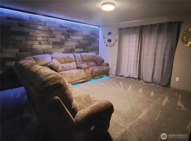 living room with wood wall & sofa LED's