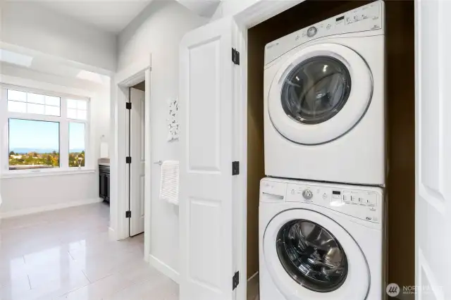 Stackable washer and dryer conveniently located in the primary suite bathroom