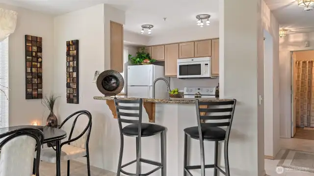 Convenient breakfast bar provides additional dining space