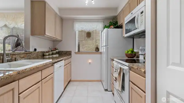 Slab granite countertops enhance the kitchen