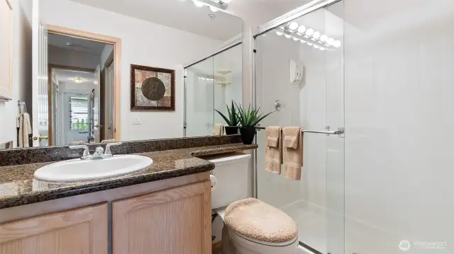 Updated primary bath has easy-entry shower and granite counters