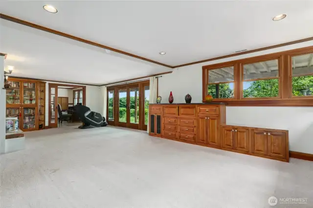 Family room on the lower level features extensive built-in cabinetry