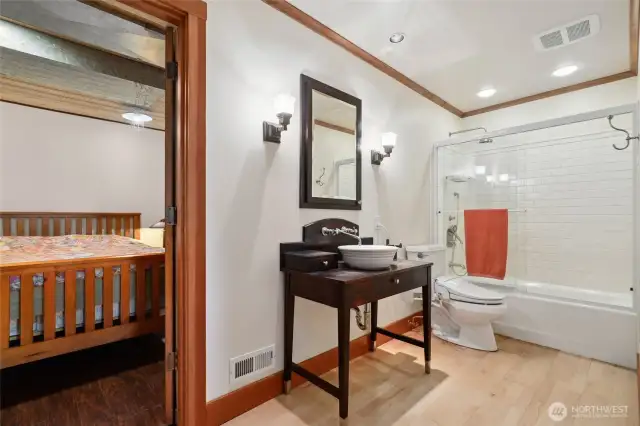 The lower full bath sits between the den and lower bedroom