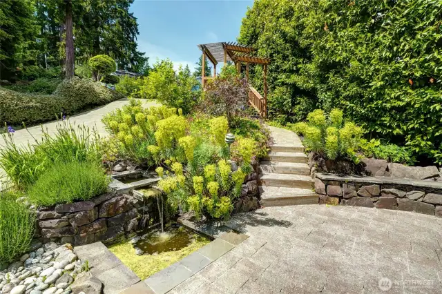 the front patio has water fountain and a stairway to the street