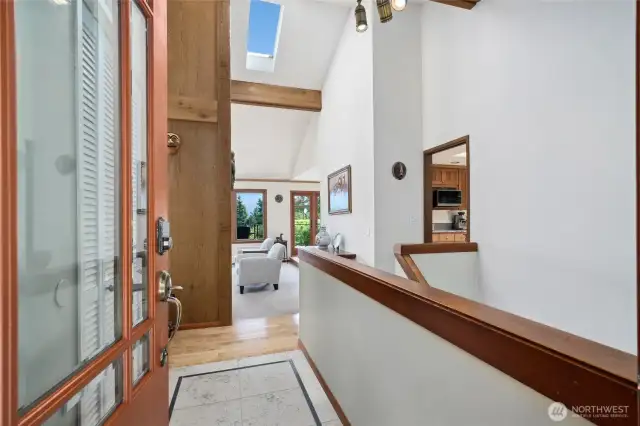 The tiled entry leads to the vaulted living room