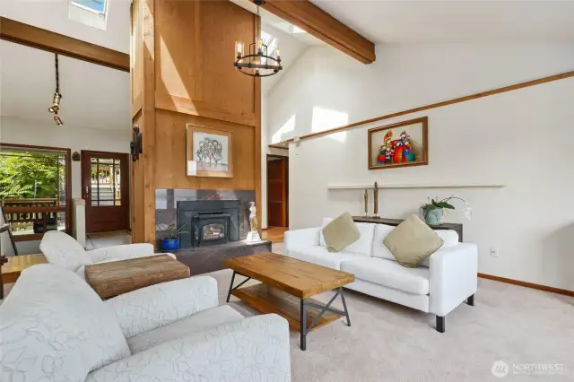 The soaring gas log fireplace features cedar paneling and stained wood beams