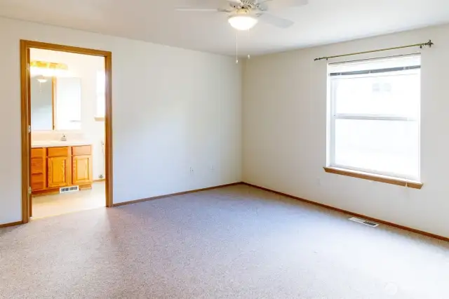 Spacious Primary bedroom with ceiling fan and walk-in-closet.