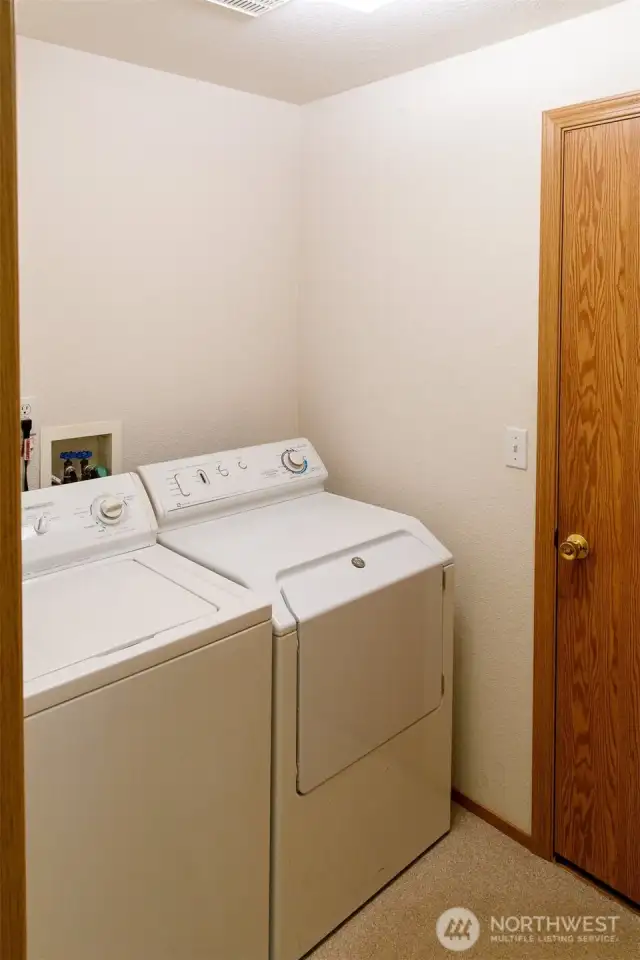 Laundry room with linen closet located opposite of the washer and dryer.