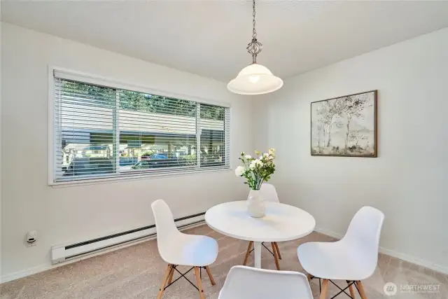 A look at the spacious dining room with updated paint, carpet and light fixture. The unit is in the rear of the complex and all units have double paned windows so the unit is quiet.