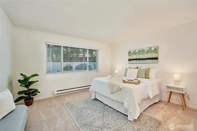The primary bedroom is huge! It's also located in the rear corner of the complex, far away from any traffic noise. As you can see, it's move in ready with new paint and carpet. It also features his and hers closets and an en-suite 3/4 bath.
