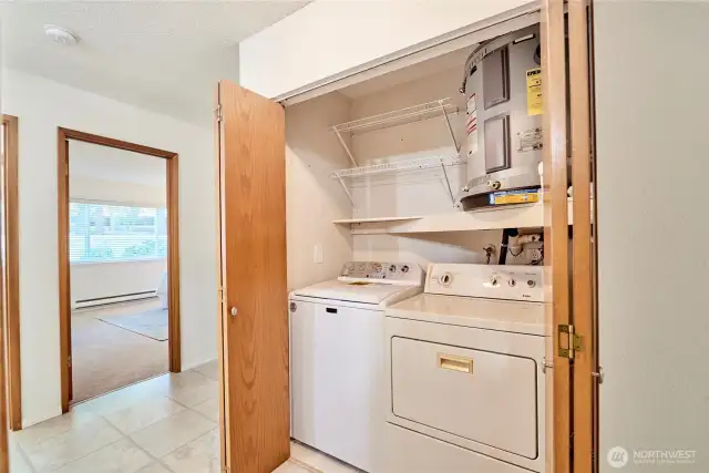 The side by side washer and dryer is conveniently located in an oversized hall closet.
