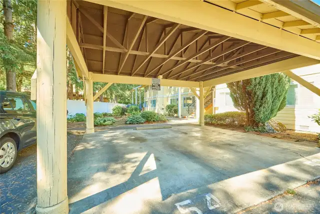 The unit is assigned parking spot #54 in the covered carport. You can see the entrance to the unit right behind the parking spot.