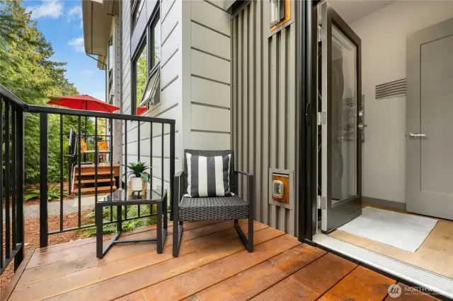 From the laundry area you can step out to your back yard space. Nice room here for a BBQ or extra storage space for gear. There is an access lane for residents that is behind the building. You can pull up and unload your groceries straight into your kitchen.