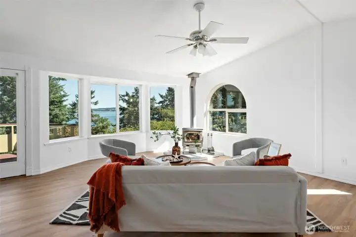 Large living room with expansive views and a wood stove to keep you cozy warm in the winter!