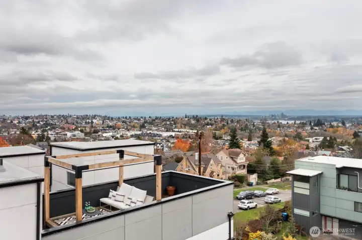 An aerial view of the rooftop deck and seating arrangements. Gazebo is covered in the warm weather months. City of Bellevue in the background to the east.