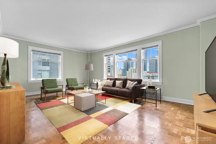Spacious and light filled living room with radiant heat, and original parquet floors.   Virtually staged.
