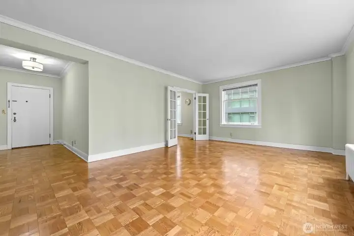 Living room view looking into the dining area.  French doors lead to the dining area and vintage kitchen.