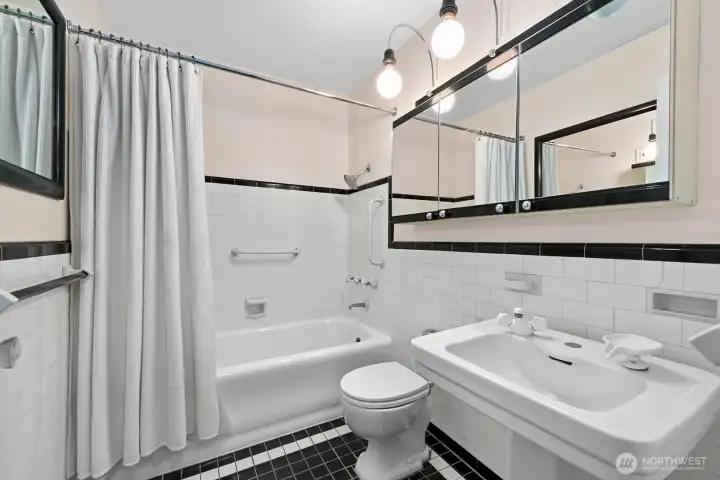 Vintage charm, Tiled full bath with pedestal sink.