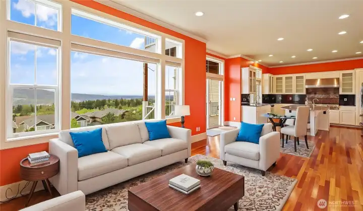 Sunlit family room featuring gleaming hardwood floors, custom built-in shelving, and a cozy gas fireplace for ultimate comfort. *Virtually Staged*
