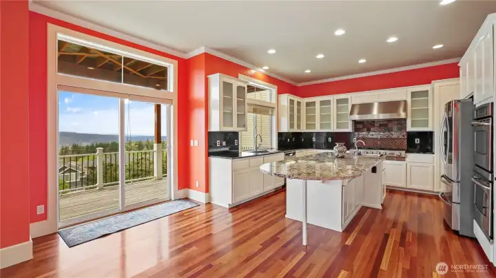 Kitchen highlights include a built-in wine refrigerator, under-cabinet lighting for both function and ambiance, and convenient roll-out shelves that make storage easily accessible.