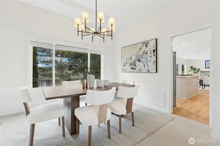 Adjoining Dining Room located between the Living room and Kitchen overlooks the backyard.