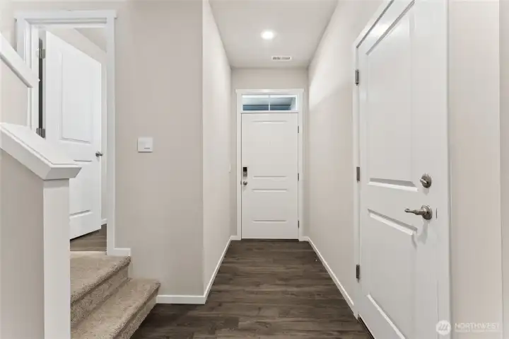 Welcoming foyer and entry with luxury laminate plank flooring. Powder room just off the stairs leading to the 2nd floor. Photos are representative only and may display different color package and/or upgrades.