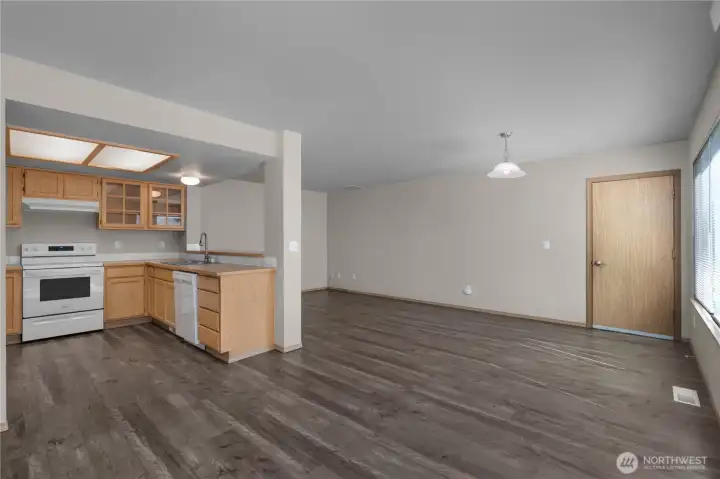 LVP flooring runs through dining, family room and kitchen.